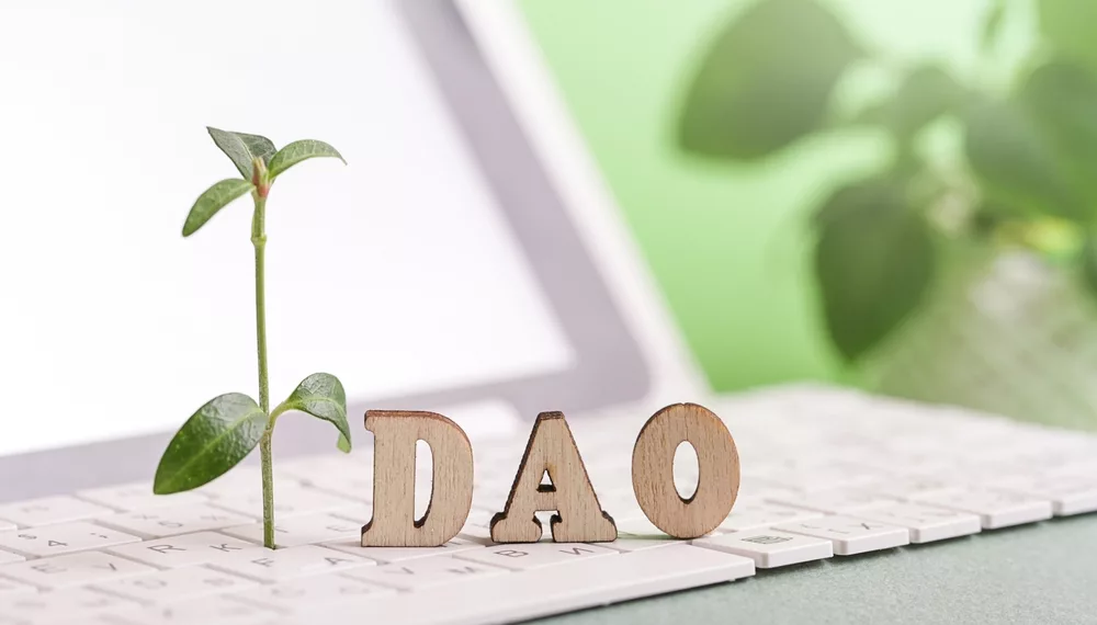 DAO is spelled on a keyboard to depict decentralized autonomous organization.