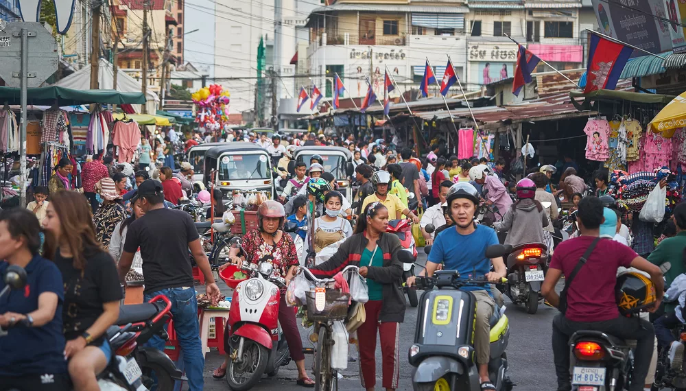 Busy street scene in Phnom Penh used to illustrate article about crypto's development in Cambodia.